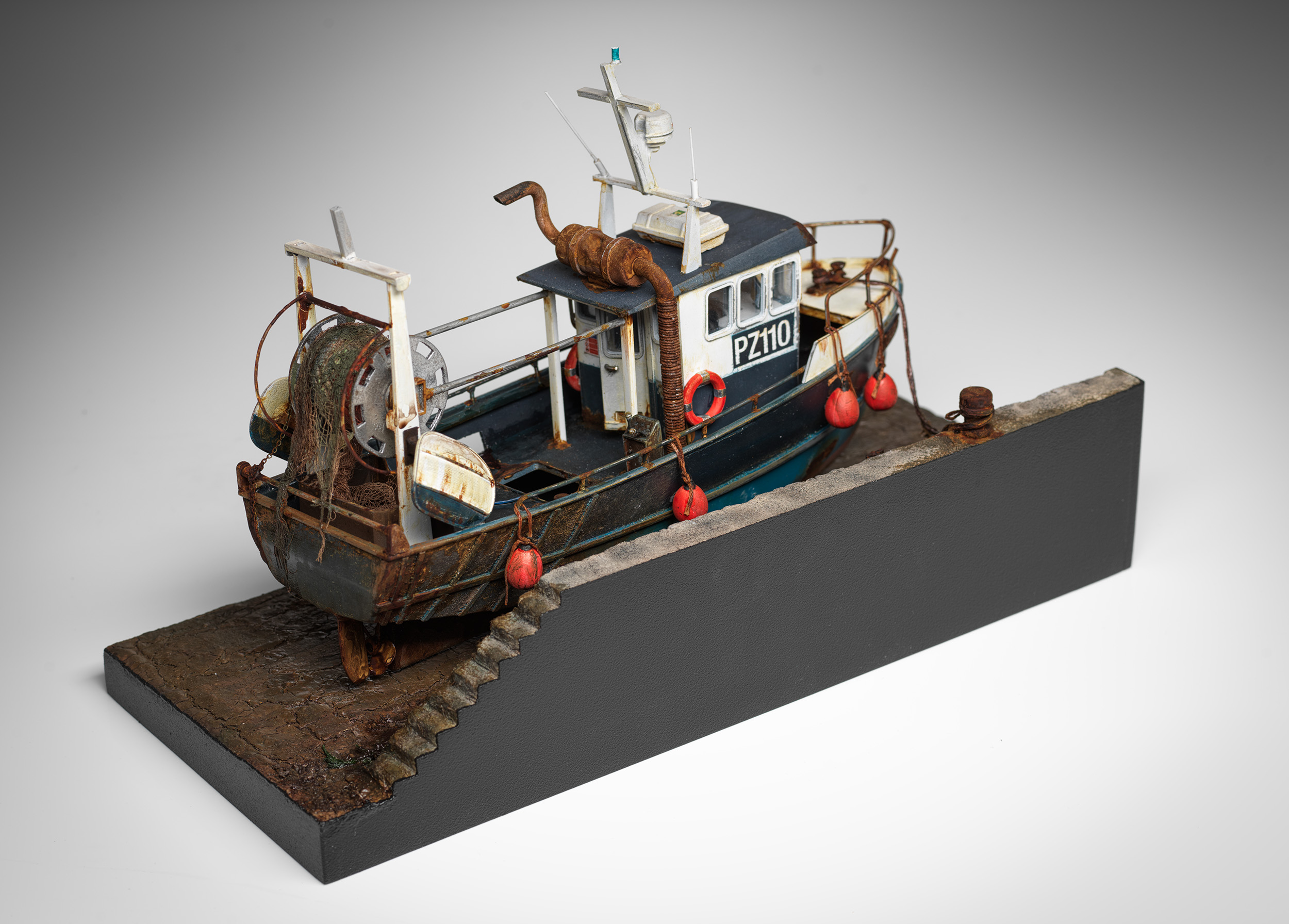 Doris viewed from behind the harbour wall, showing the opposite side of her wheelhouse, working deck, net drum and stern steps