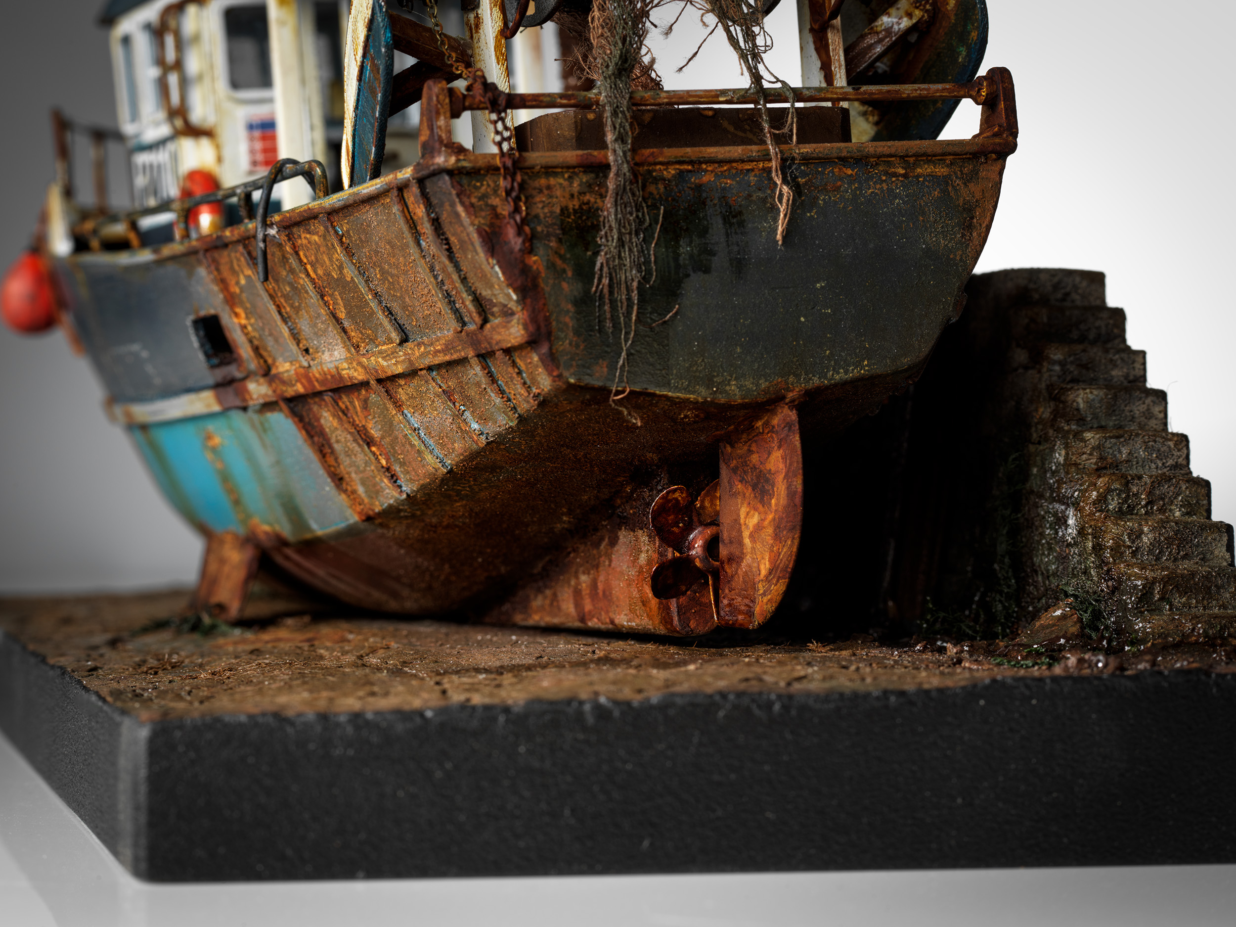 Doris's propeller and rusted rudder beside the harbour steps